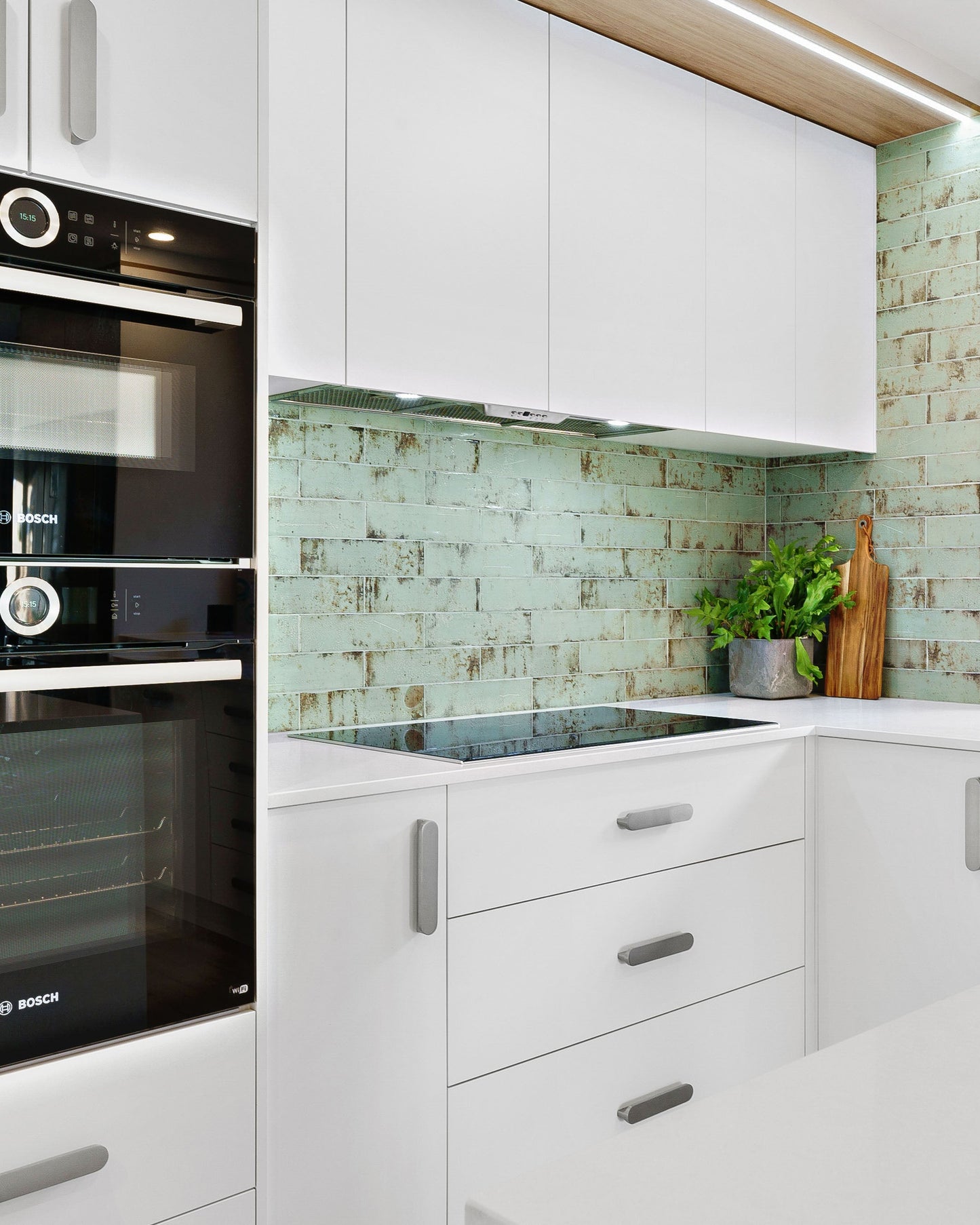 Rustic tiles, timber trims and modern appliances in a sustainably built kitchen.